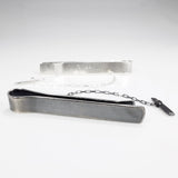 Sterling silver tie bar in black oxidized and brushed silver finish.